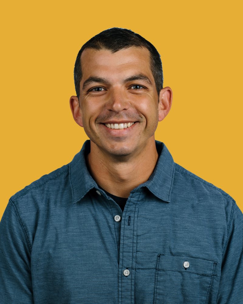 Andy Bedford smiling, in a blue button-down shirt